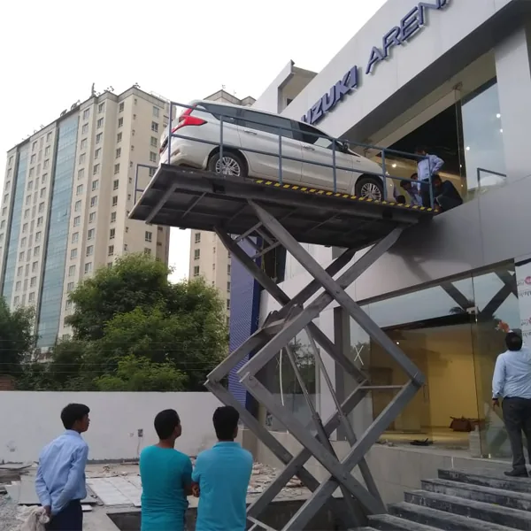 Essem Engineers car lift raising a vehicle at a Maruti Suzuki Arena showroom